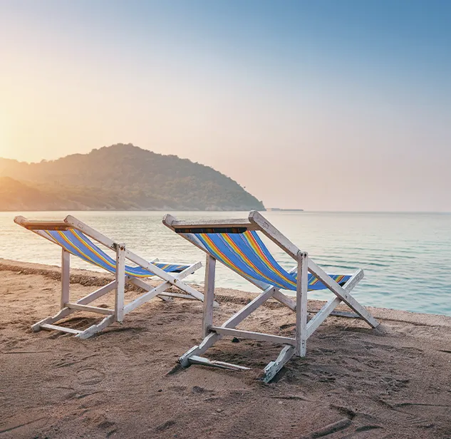 empty beach chairs during sunset on a sardinian beach