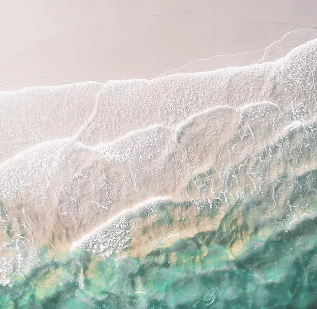 aerial view of sea waves on a sandy beach near bonifacio
