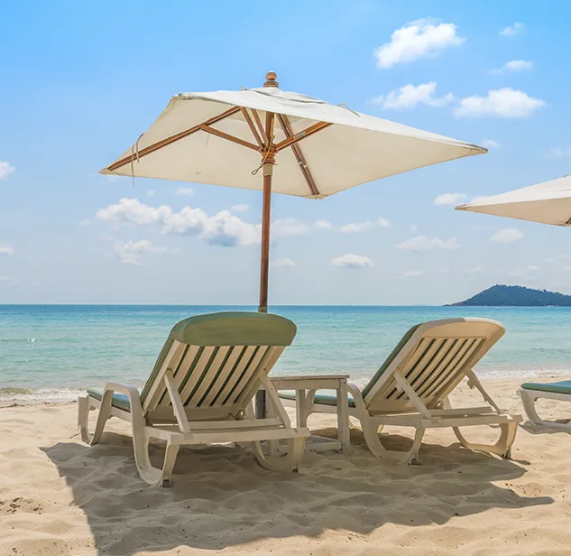 White sand beach with sunbeds and umbrella, calm turquoise waters close to bonifacio