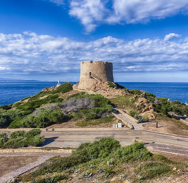 the longonsardo tower during a beautiful summer day with few clouds and the sea on the background